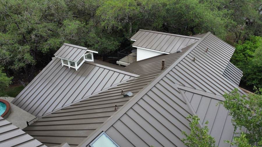 Close view of bronze standing seam panels, valleys and a dormer