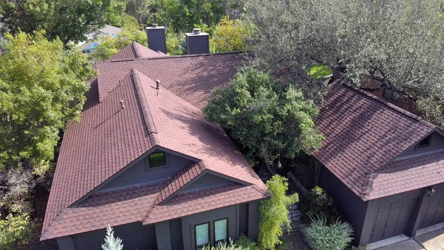 New red architectural shingle roof on a dark gray home