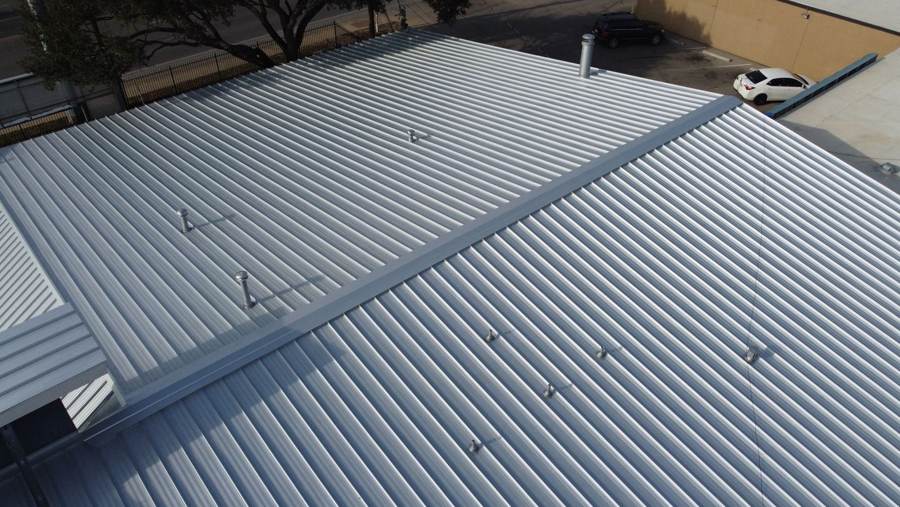 Silver metal roof with vents on a commercial building