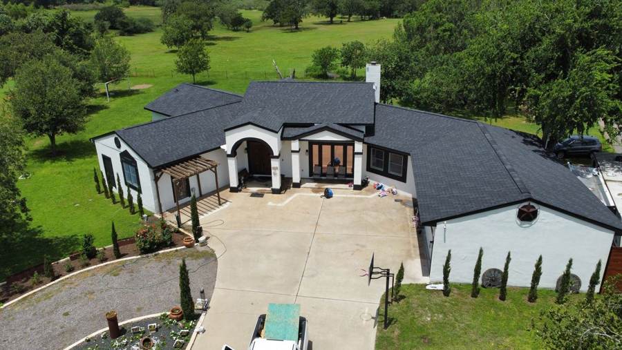 Black shingle roof on a white stucco ranch home
