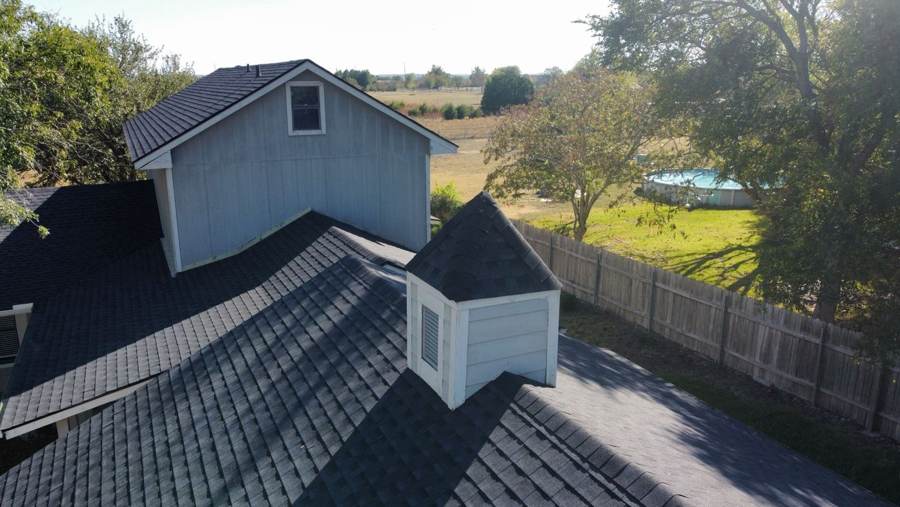 New charcoal shingles around a roof cupola