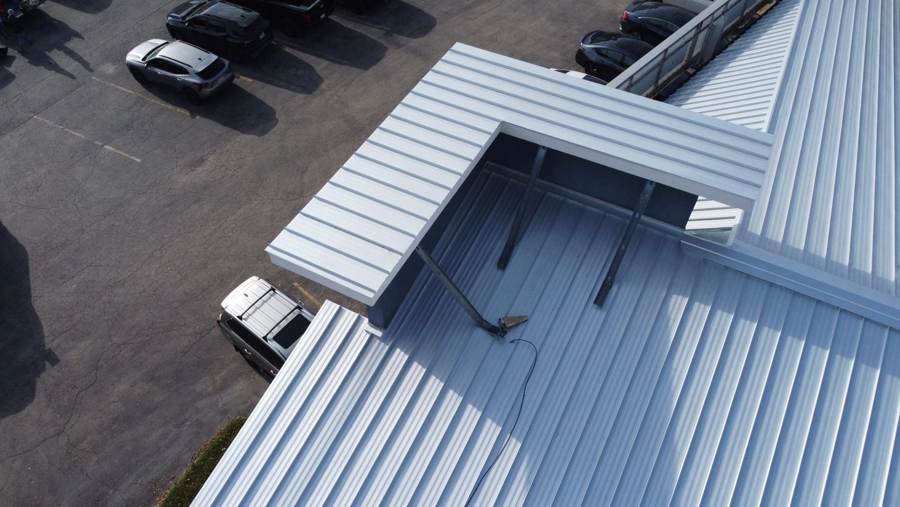White metal roof and parapet detail on a commercial building